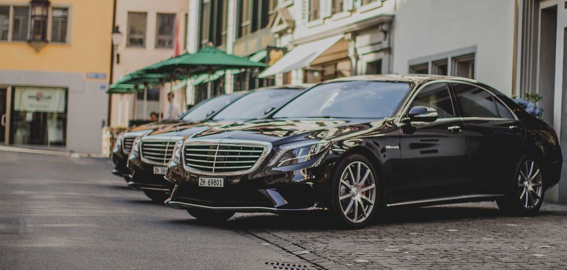 Line of Mercedes-Benz limousines waiting at the kerb