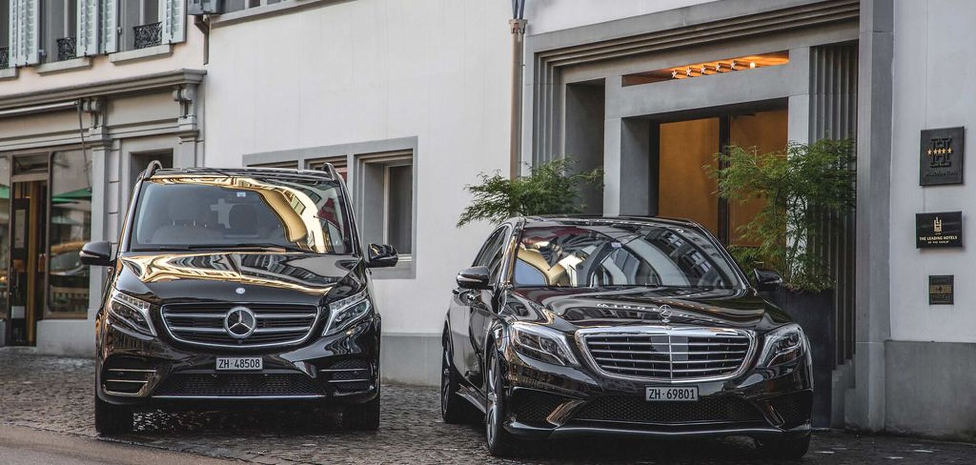 Mercedes-Benz van and limousine outside a hotel